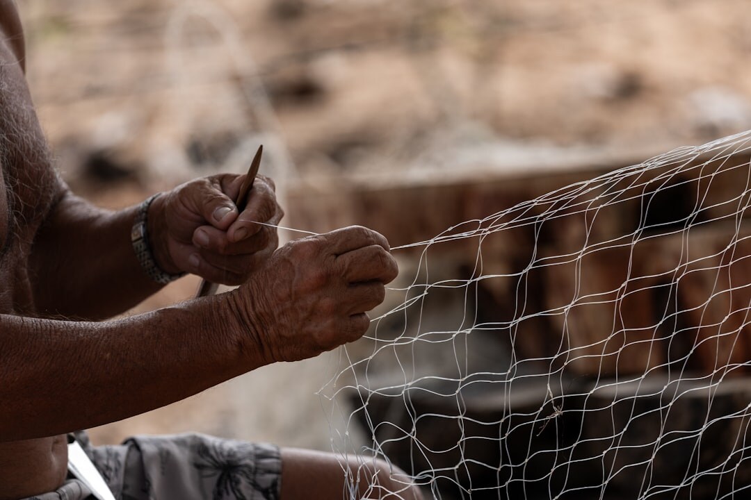 Fisherman mending nets at a small Chilean caleta