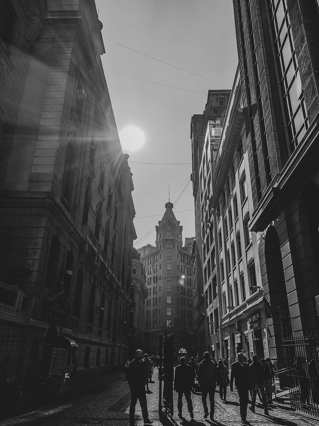 Documentary photograph of a busy street in Santiago Chile at golden hour with pedestrians and old buildings