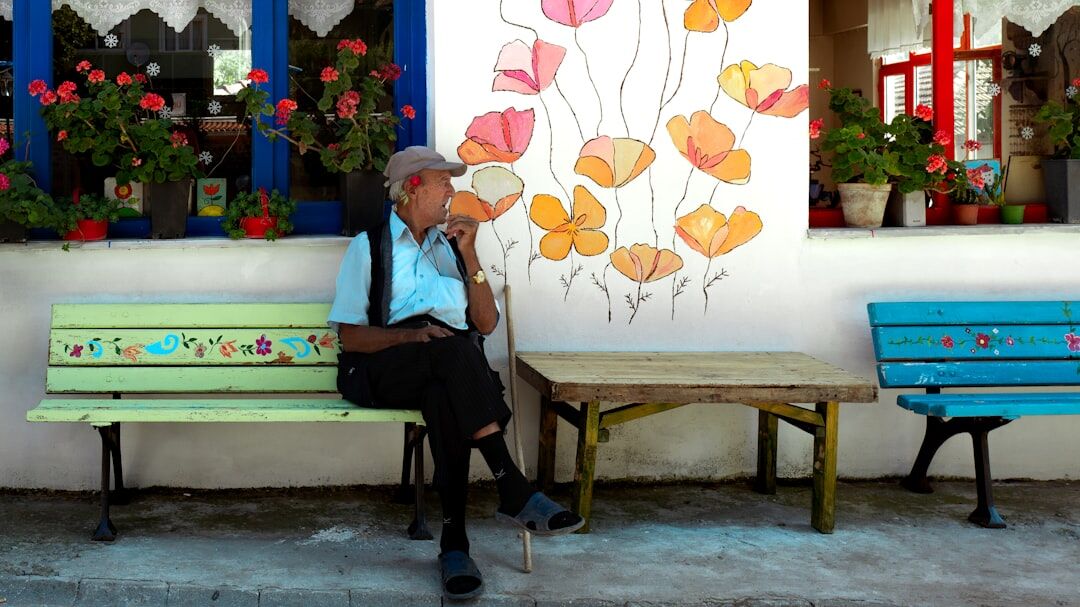 Portrait of an elderly Chilean man sitting on a plaza bench