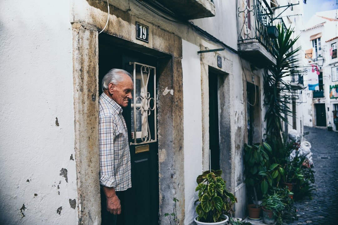 elderly man sitting on doorstep